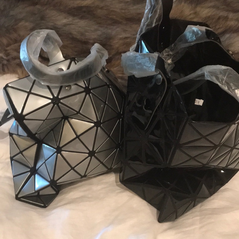 Two handbags with zip closure at top.